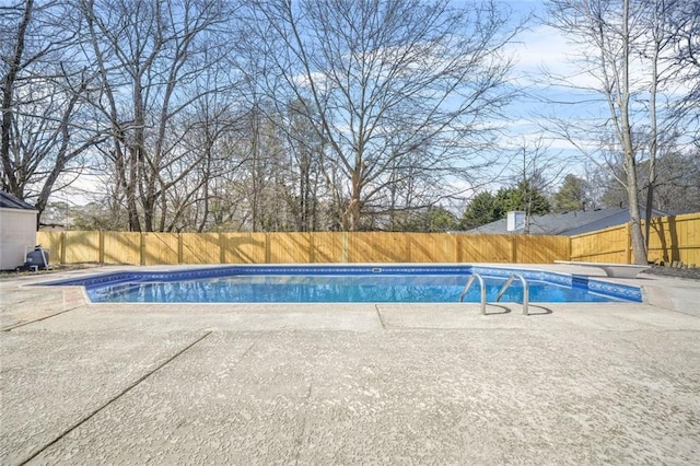 view of pool with a fenced backyard, a patio, and a diving board