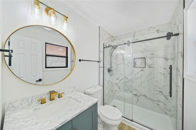 bathroom featuring a marble finish shower, toilet, and vanity