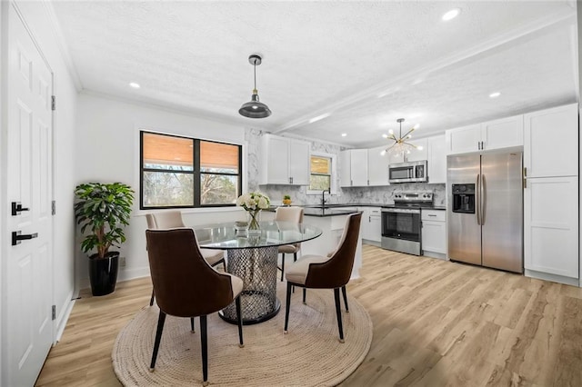 dining room featuring a textured ceiling, light wood-style floors, recessed lighting, baseboards, and ornamental molding