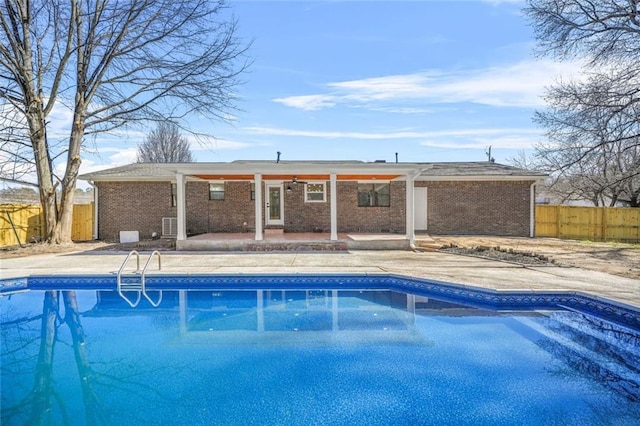 view of swimming pool with a patio area, a fenced backyard, and ceiling fan