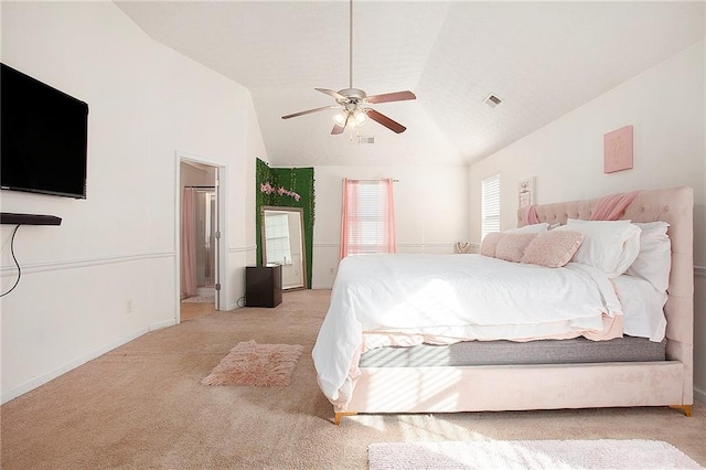 bedroom featuring connected bathroom, light colored carpet, vaulted ceiling, and ceiling fan