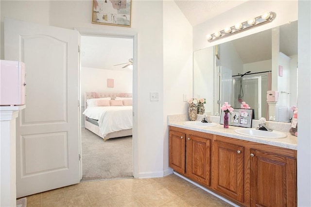 bathroom with ceiling fan, a shower with door, and vanity