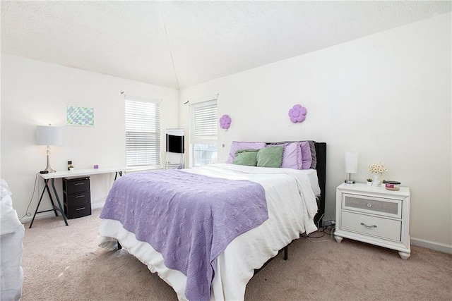 carpeted bedroom with vaulted ceiling