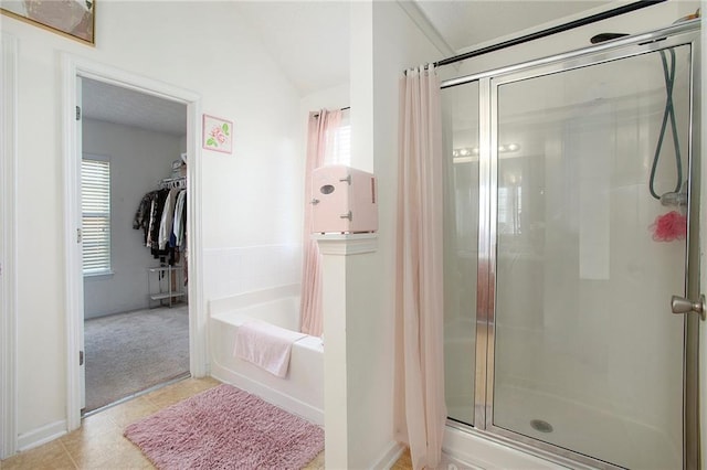 bathroom featuring tile patterned floors, independent shower and bath, and a healthy amount of sunlight