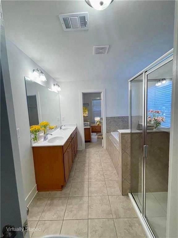 1147 Halletts Peak Pl, Lawrenceville, GA 30044 - full bathroom featuring a stall shower, double vanity, a bath, tile patterned floors, and baseboards
