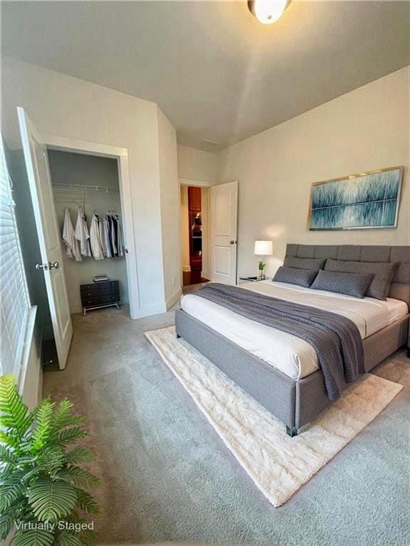 1147 Halletts Peak Pl, Lawrenceville, GA 30044 - bedroom with carpet, a closet, baseboards, and a spacious closet