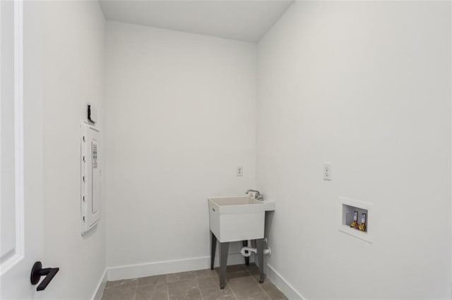 washroom with laundry area, hookup for a washing machine, electric panel, and baseboards