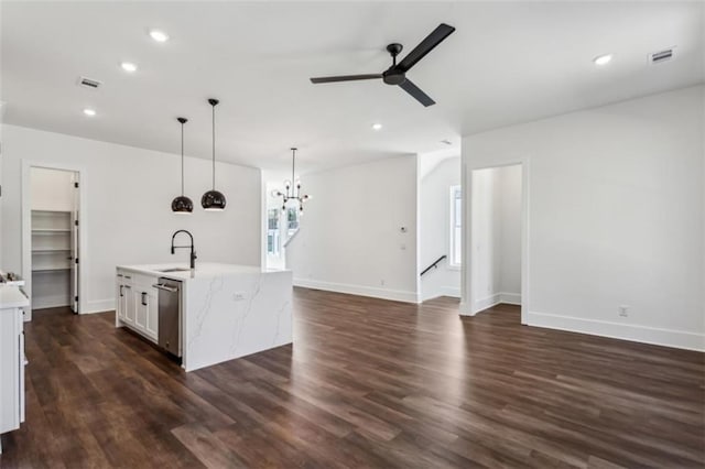 kitchen featuring visible vents, dark wood-type flooring, ceiling fan with notable chandelier, a sink, and dishwasher