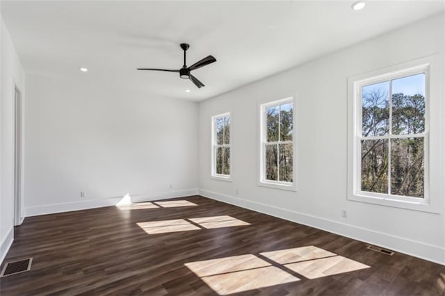 unfurnished room with recessed lighting, wood finished floors, visible vents, and baseboards