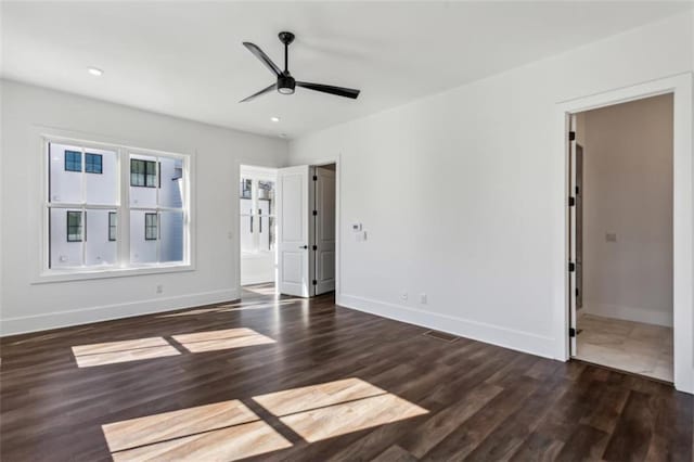 empty room featuring recessed lighting, baseboards, wood finished floors, and ceiling fan