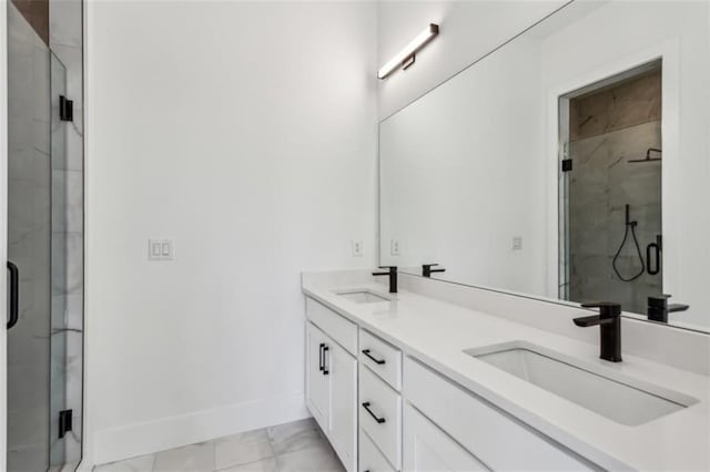 bathroom featuring a shower stall, baseboards, and a sink