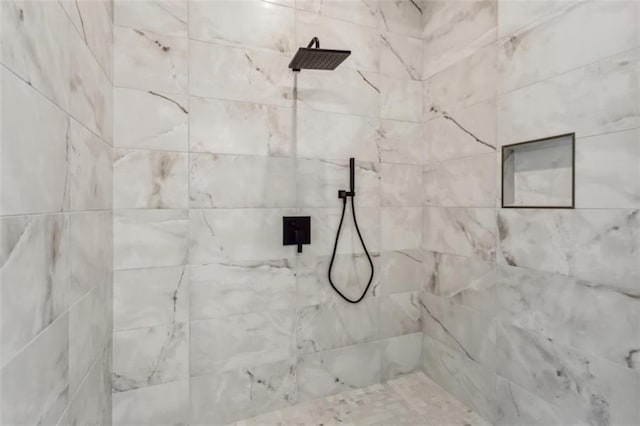 full bath with a tile shower