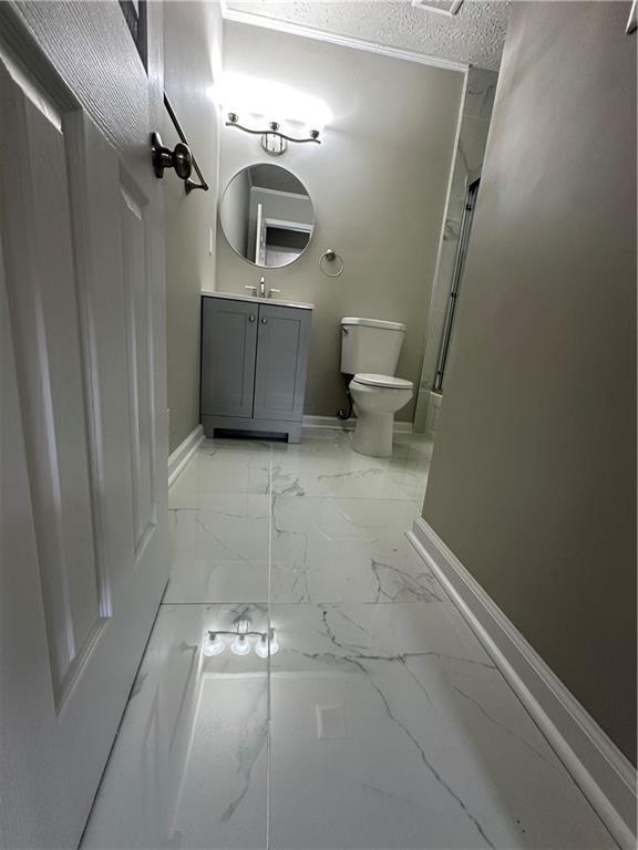 3967 Evelyn Dr, Powder Springs, GA 30127 - full bath with an enclosed shower, toilet, baseboards, and marble finish floor