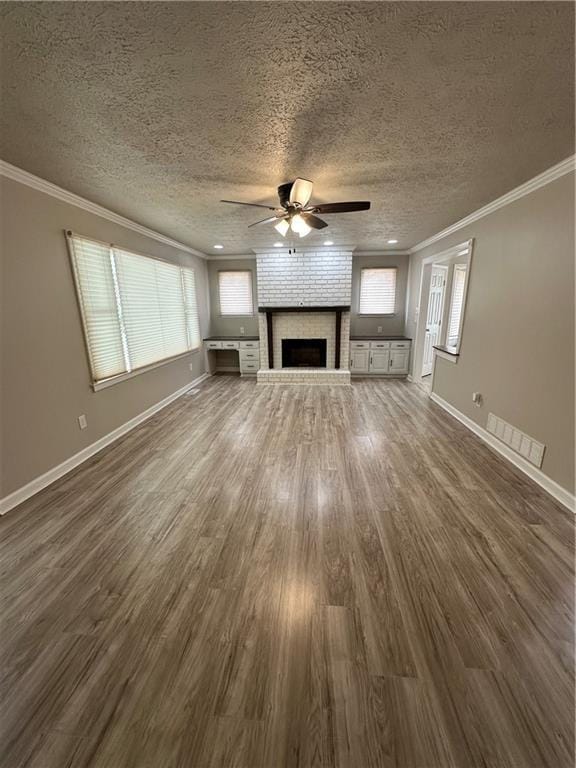 3967 Evelyn Dr, Powder Springs, GA 30127 - unfurnished living room featuring dark wood finished floors, crown molding, a fireplace, and ceiling fan