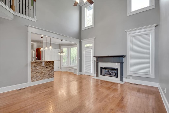 3085 Woodbridge Ln, Canton, GA 30114 - entryway with stairs, light wood-type flooring, ornamental molding, a towering ceiling, and baseboards