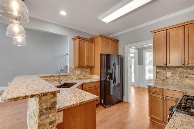 3085 Woodbridge Ln, Canton, GA 30114 - kitchen with black appliances, a sink, a peninsula, tasteful backsplash, and ornamental molding