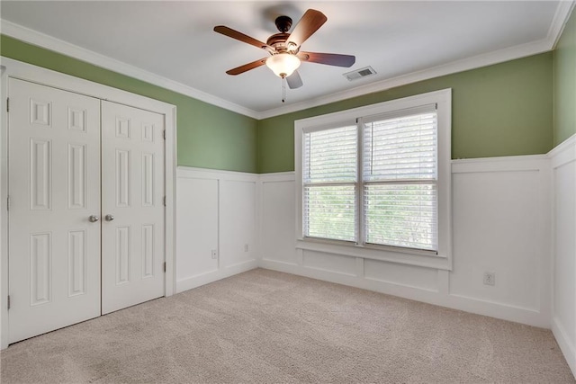 3085 Woodbridge Ln, Canton, GA 30114 - unfurnished bedroom featuring a wainscoted wall, crown molding, a decorative wall, carpet, and a closet