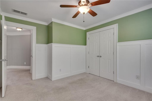 3085 Woodbridge Ln, Canton, GA 30114 - unfurnished bedroom featuring a decorative wall, carpet, crown molding, wainscoting, and a closet