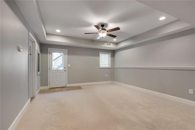 3085 Woodbridge Ln, Canton, GA 30114 - unfurnished room with a tray ceiling, light colored carpet, ceiling fan, recessed lighting, and baseboards