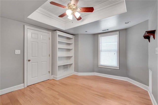 3085 Woodbridge Ln, Canton, GA 30114 - unfurnished bedroom with light wood-style floors, a tray ceiling, baseboards, ornamental molding, and a ceiling fan