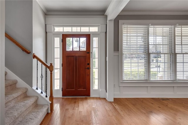 3085 Woodbridge Ln, Canton, GA 30114 - foyer with light wood-style flooring, a decorative wall, stairway, crown molding, and a wainscoted wall