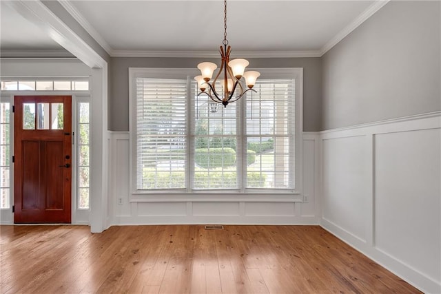 3085 Woodbridge Ln, Canton, GA 30114 - foyer featuring a decorative wall, a chandelier, hardwood / wood-style flooring, wainscoting, and ornamental molding