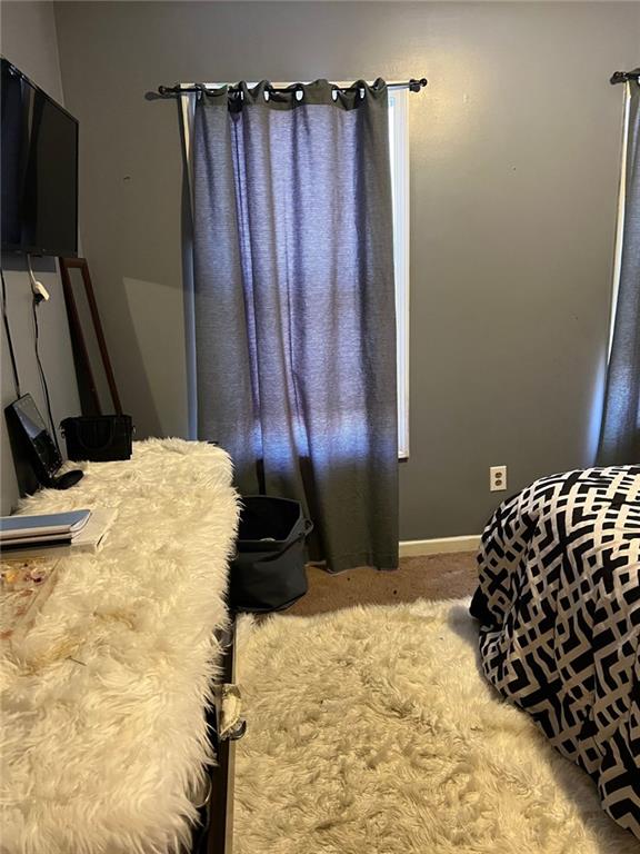 bedroom featuring carpet floors and baseboards