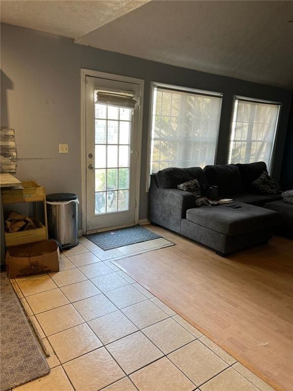 entryway with a textured ceiling and light tile patterned flooring