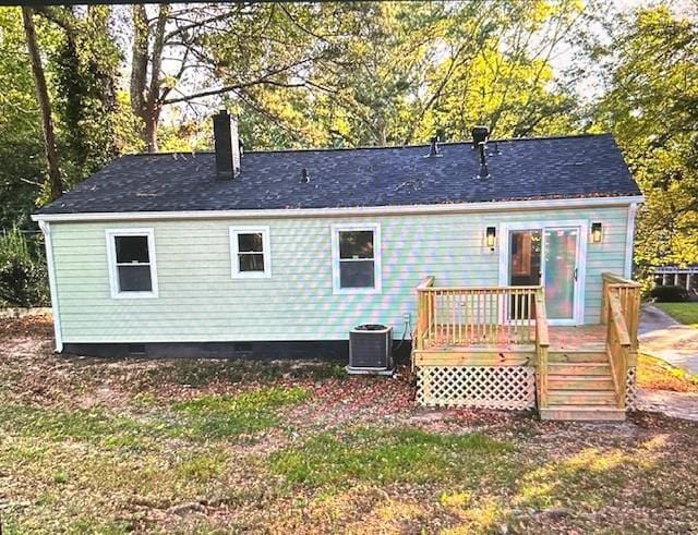 back of property with central AC unit and a wooden deck