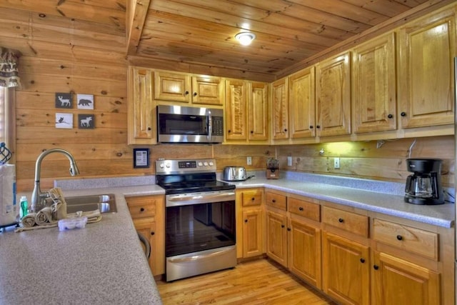 kitchen with appliances with stainless steel finishes, light hardwood / wood-style floors, sink, wooden walls, and wooden ceiling