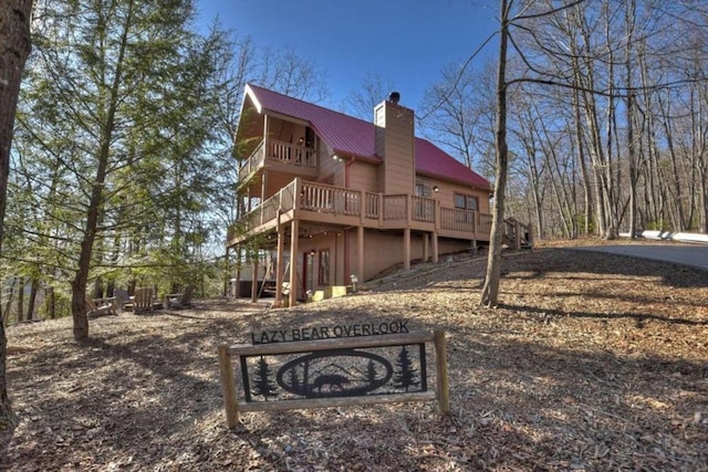 rear view of property with a wooden deck