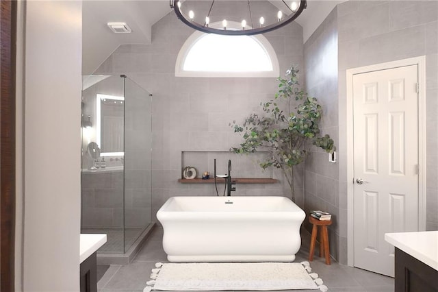 1235 Grand View Dr SE, Smyrna, GA 30126 - full bathroom with tile walls, tile patterned flooring, a freestanding bath, a stall shower, and vanity