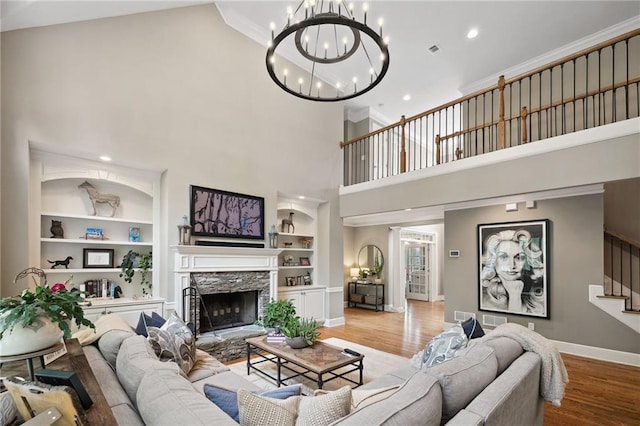 1235 Grand View Dr SE, Smyrna, GA 30126 - living area featuring built in shelves, baseboards, a towering ceiling, wood finished floors, and a chandelier