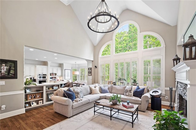 1235 Grand View Dr SE, Smyrna, GA 30126 - living room with wood finished floors, a chandelier, high vaulted ceiling, and a premium fireplace