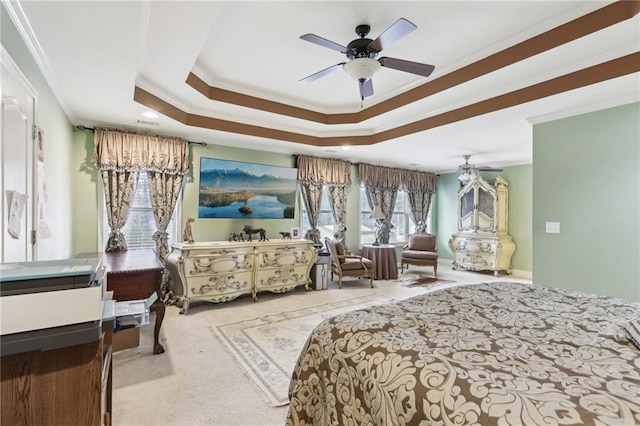 bedroom featuring a raised ceiling, ornamental molding, light carpet, and ceiling fan