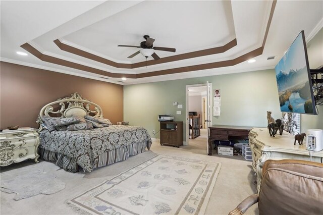 carpeted bedroom featuring crown molding, ceiling fan, and a tray ceiling