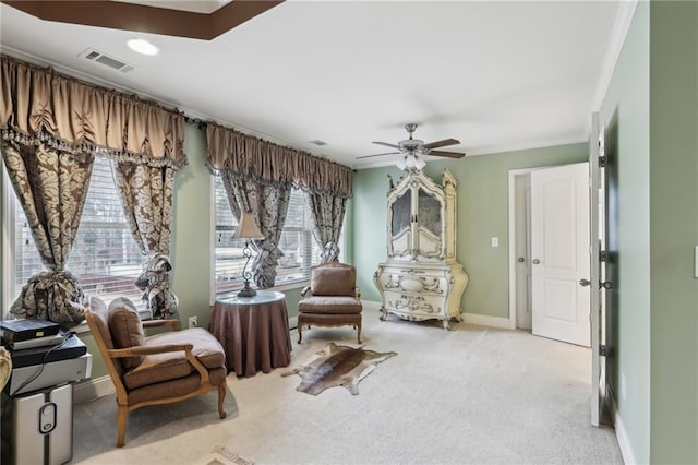 sitting room featuring crown molding, light carpet, and ceiling fan