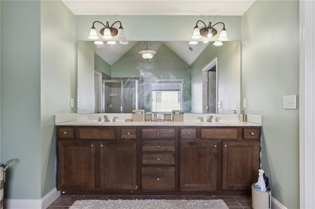 bathroom featuring tile patterned flooring, vanity, lofted ceiling, and walk in shower