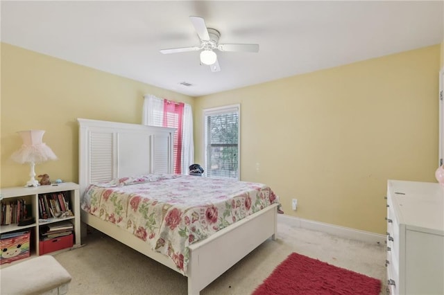 bedroom featuring ceiling fan and light carpet