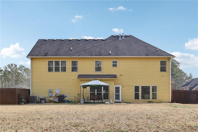 rear view of property with central air condition unit