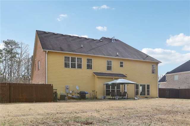 rear view of property featuring central AC