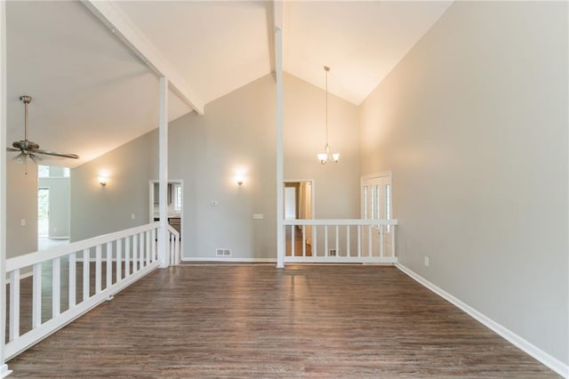 unfurnished room with wood finished floors, ceiling fan with notable chandelier, high vaulted ceiling, beam ceiling, and baseboards