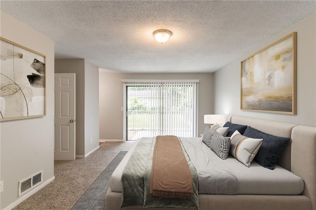 carpeted bedroom featuring a textured ceiling, baseboards, and visible vents