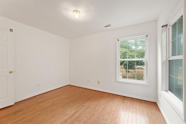 spare room with light hardwood / wood-style flooring