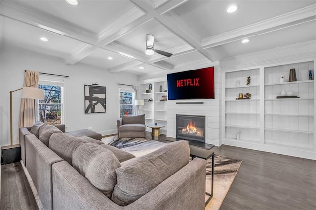 living area with a large fireplace, coffered ceiling, beam ceiling, and a ceiling fan