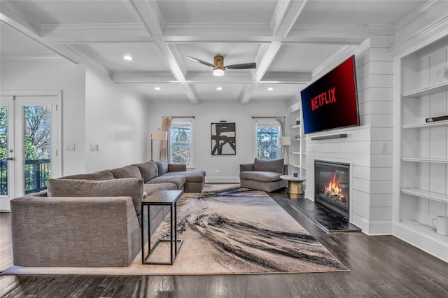 living area featuring a large fireplace, coffered ceiling, beamed ceiling, and baseboards