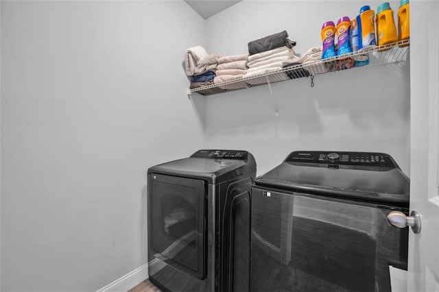 laundry room with laundry area, independent washer and dryer, and baseboards