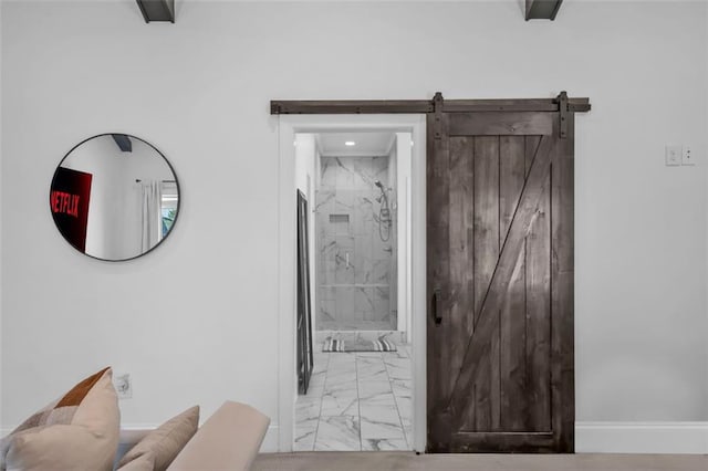 interior details with a barn door and baseboards