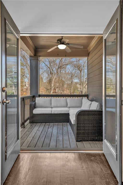 deck featuring ceiling fan and outdoor lounge area