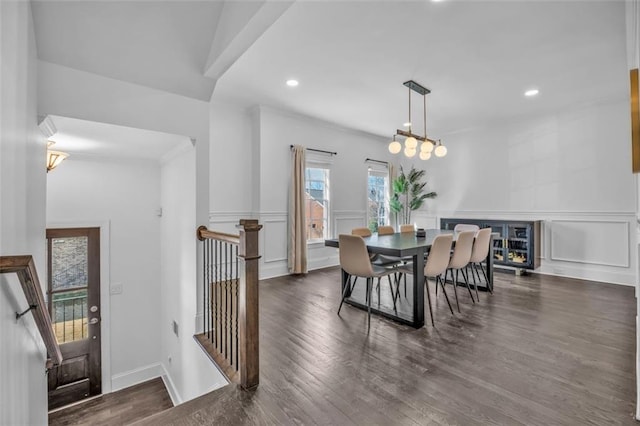 dining space featuring wainscoting, a decorative wall, wood finished floors, and recessed lighting